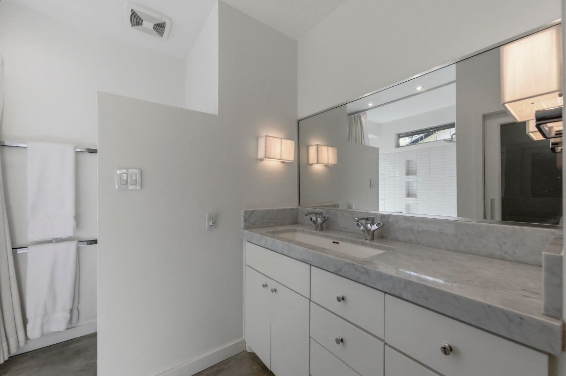 1712 West 10th Street Austin, TX 78703 - Photo 13 of 34 a bathroom with a granite countertop sink and a mirror