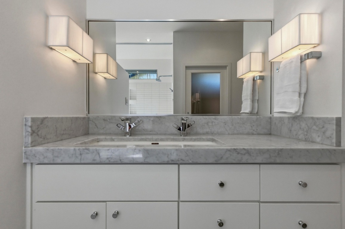 1712 West 10th Street Austin, TX 78703 - Photo 14 of 34 a bathroom with a sink and a mirror