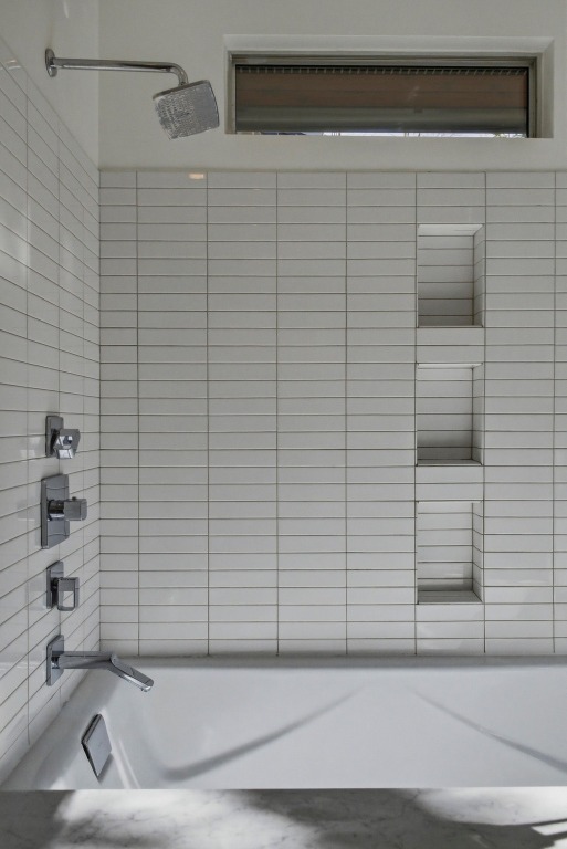 1712 West 10th Street Austin, TX 78703 - Photo 16 of 34 a bathroom with a white bathtub and a shower