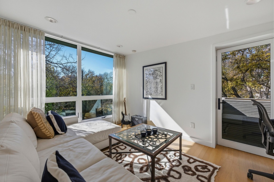 1712 West 10th Street Austin, TX 78703 - Photo 23 of 34 a living room with furniture and a floor to ceiling window