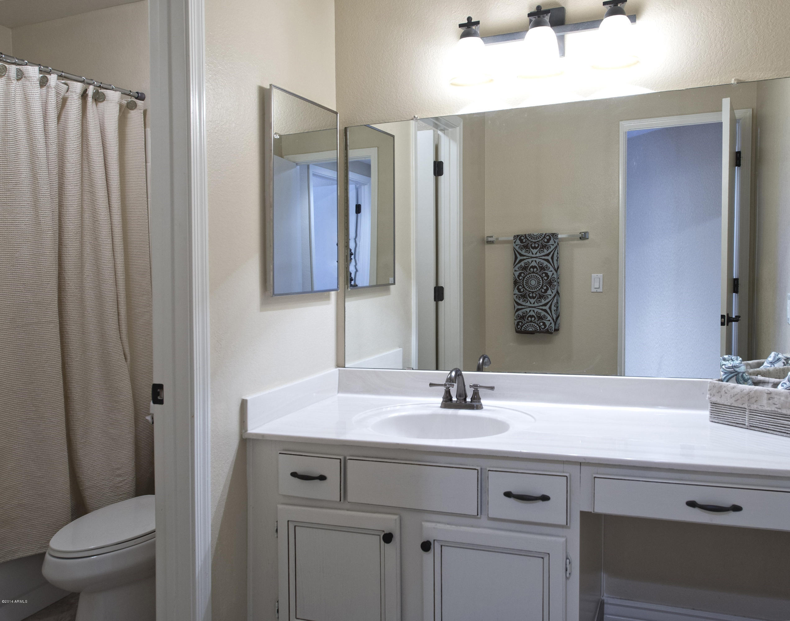 1268 East Mineral Road Gilbert, AZ 85234 - Photo 14 of 18 a bathroom with a sink toilet and shower