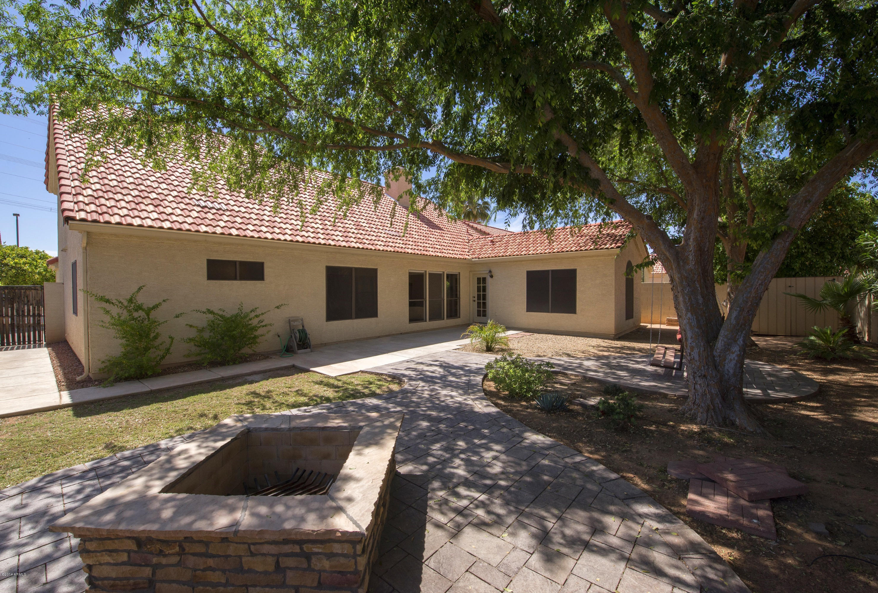 1268 East Mineral Road Gilbert, AZ 85234 - Photo 17 of 18 a view of a house with backyard and a tree