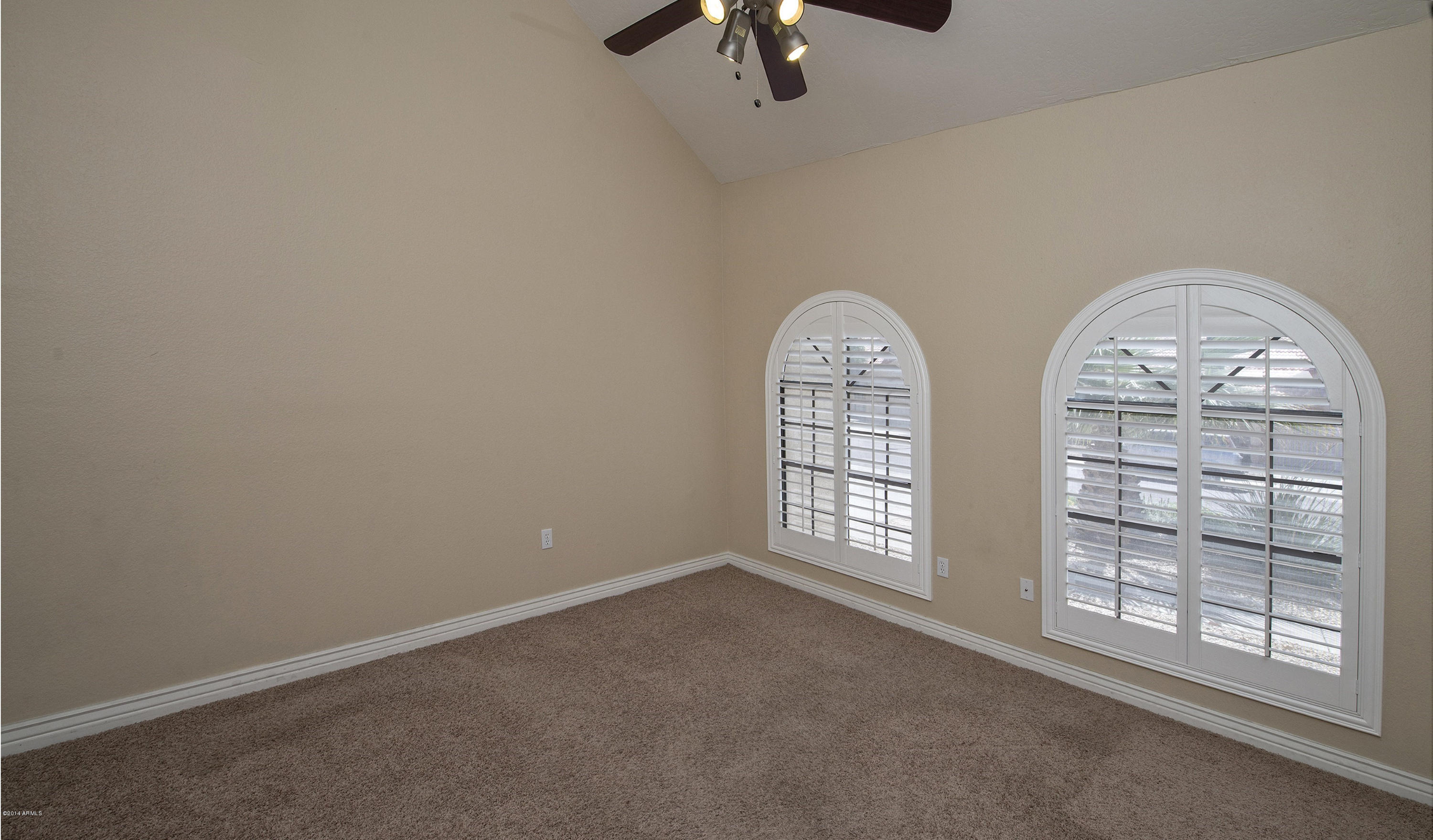 1268 East Mineral Road Gilbert, AZ 85234 - Photo 2 of 18 an empty room with windows chandelier fan and windows