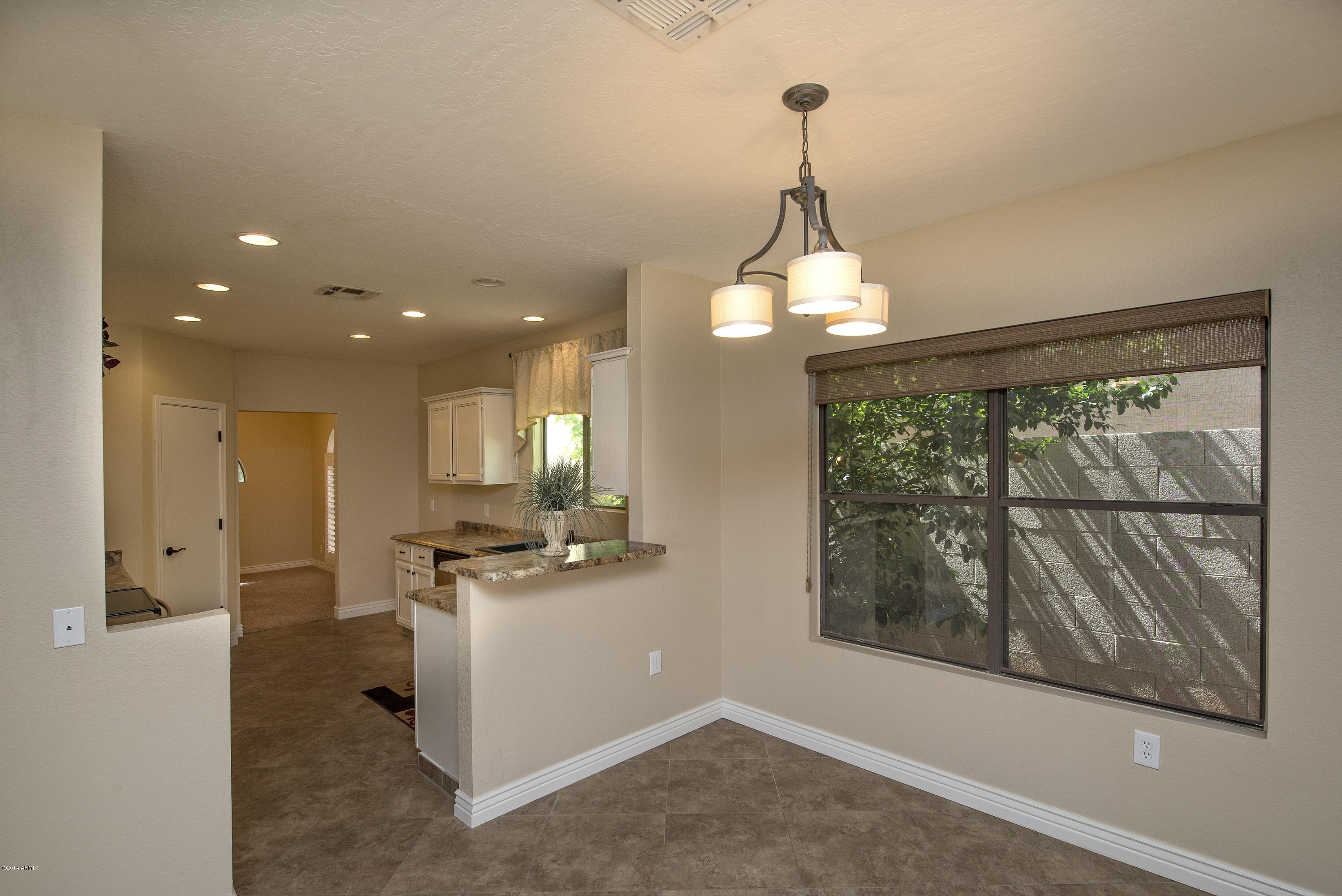1268 East Mineral Road Gilbert, AZ 85234 - Photo 6 of 18 a view of a kitchen with furniture and large windows