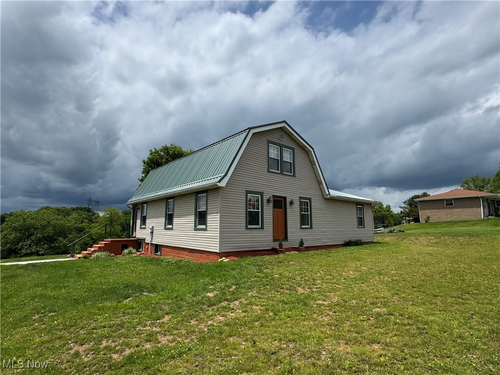 71322 Sharon Road Bridgeport, OH 43912 - Photo 2 of 39 Back of house featuring a yard, metal roof, and a gambrel roof