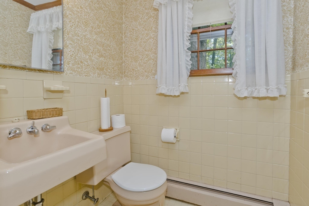 102 West Meadowview Road Holyoke, MA 01040 - Photo 27 of 39 a bathroom with a sink a toilet and shower curtain