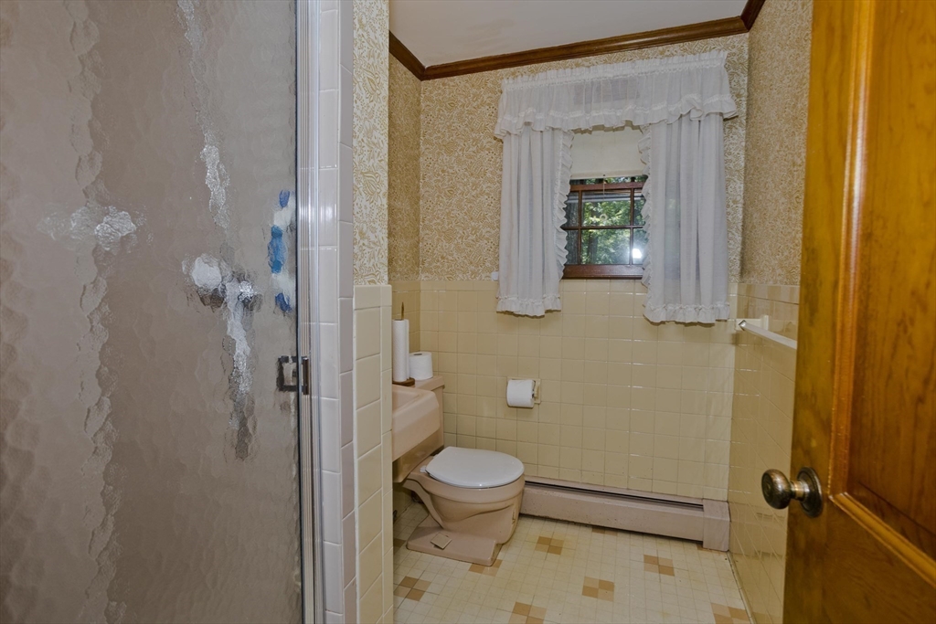 102 West Meadowview Road Holyoke, MA 01040 - Photo 28 of 39 a bathroom with a granite countertop sink a toilet and shower