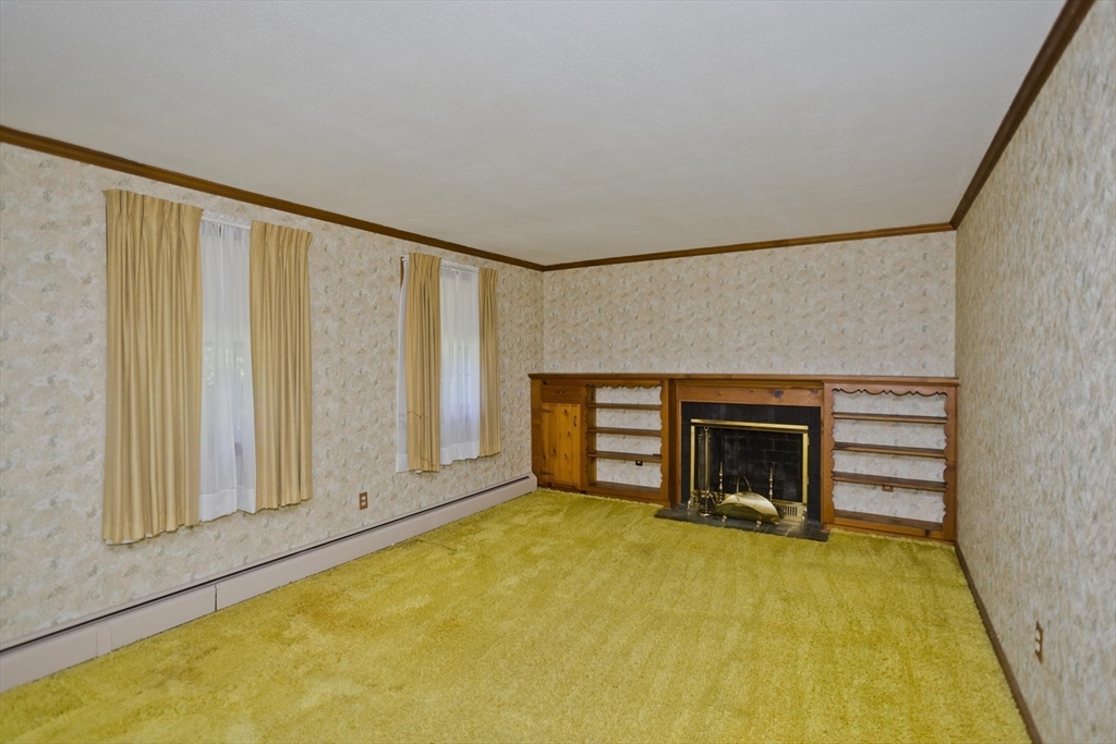 102 West Meadowview Road Holyoke, MA 01040 - Photo 5 of 39 a view of an empty room with a fireplace and a window