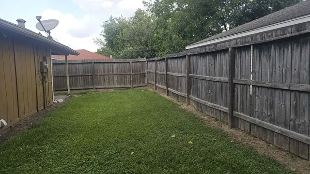 a backyard with wooden fence