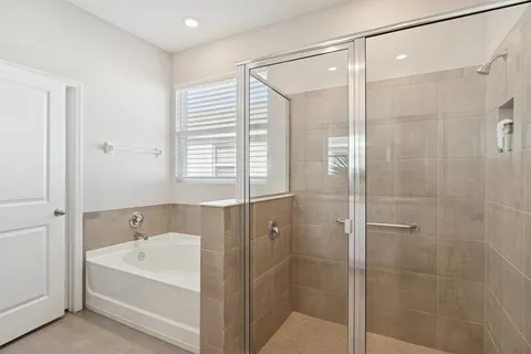 a spacious bathroom with a bathtub shower and a sink