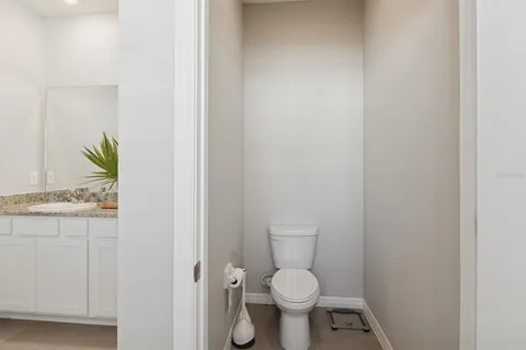 a white toilet sitting next to a sink