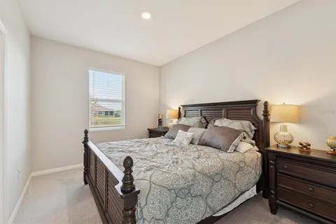 a bedroom with a bed and window