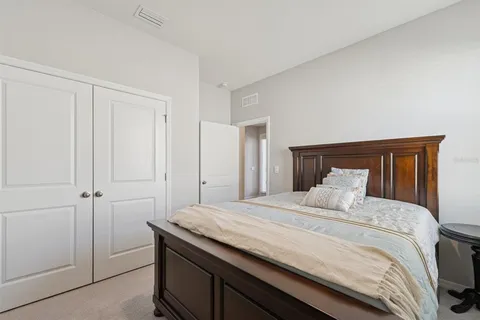 a bedroom with a bed and a mirror