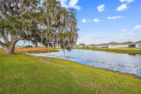 a view of a lake with houses in the back