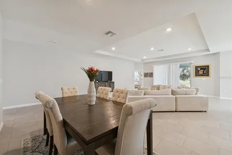 a living room with furniture a table and chairs