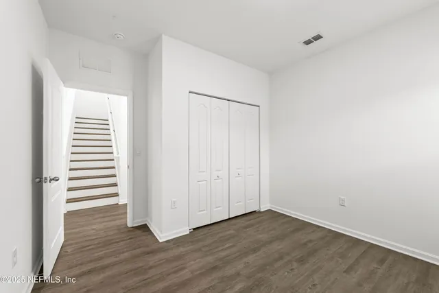 a view of a room with wooden floor