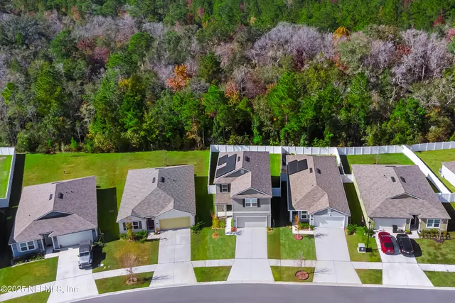 an aerial view of residential house with outdoor space and swimming pool