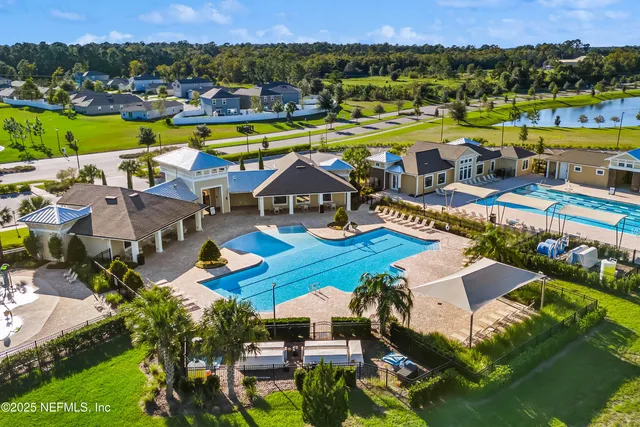 an aerial view of a houses with a big yard
