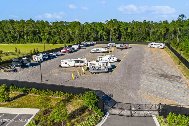an aerial view of a house with a yard basket ball court and outdoor seating