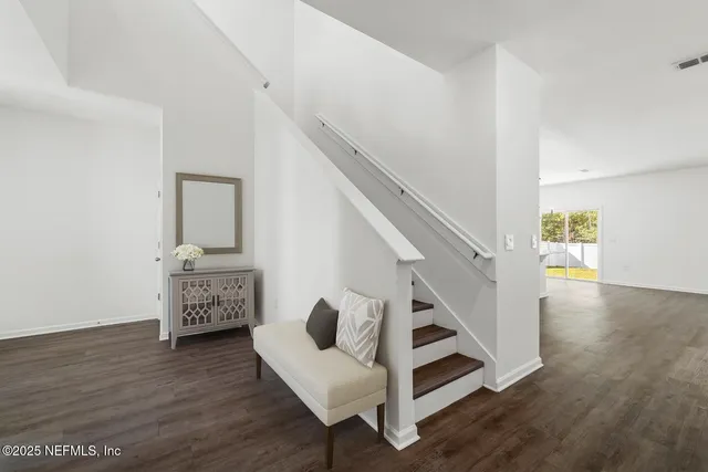 a view of entryway and hall with wooden floor