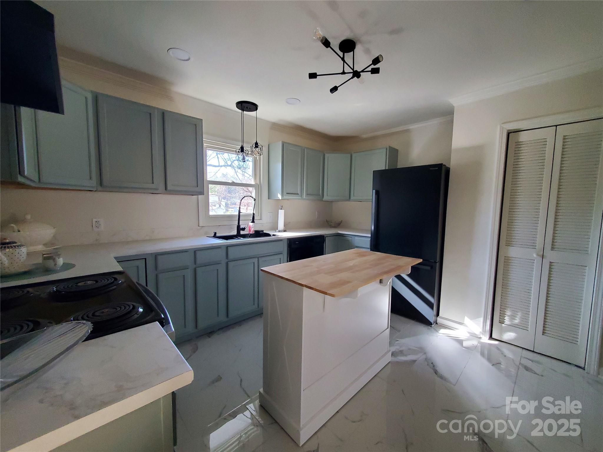 2129 Rankin Road Gastonia, NC 28056 - Photo 7 of 15 a kitchen with a sink a refrigerator and a stove top oven