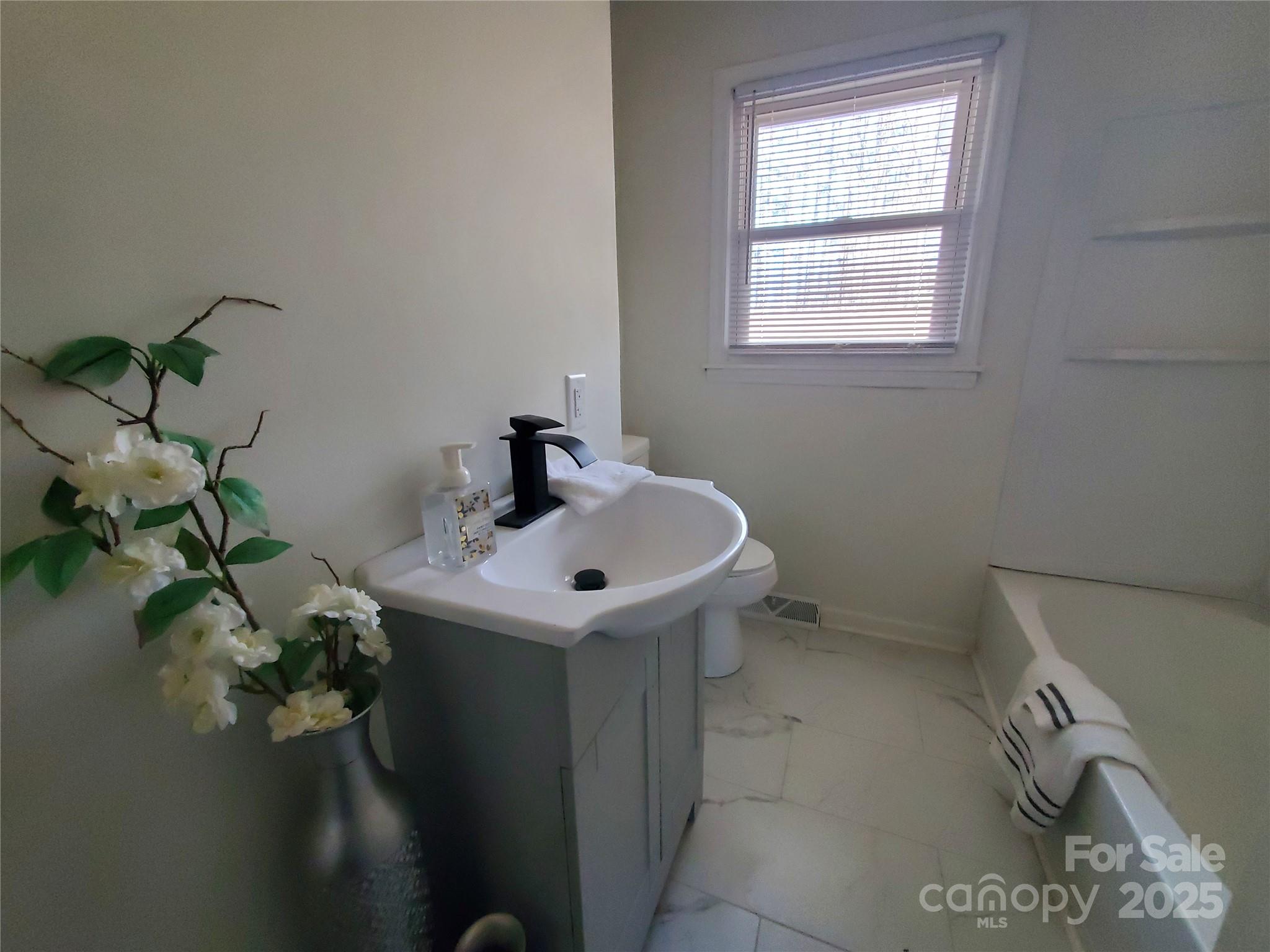 2129 Rankin Road Gastonia, NC 28056 - Photo 8 of 15 a bathroom with a sink a toilet and a window