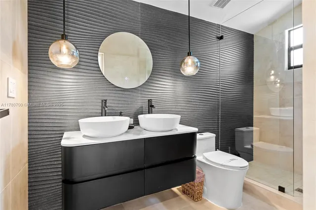 a bathroom with a toilet sink mirror and vanity