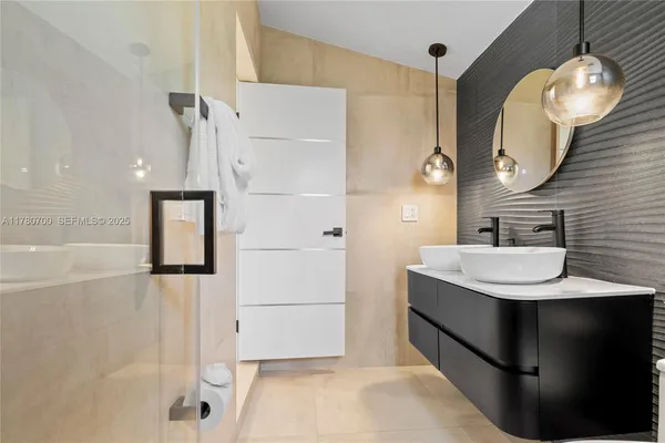 a bathroom with a sink a light fixture and a mirror