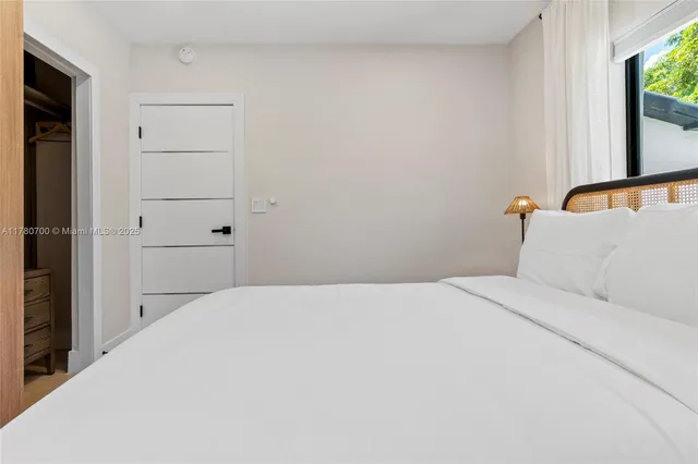 a bedroom with a bed and a mirror