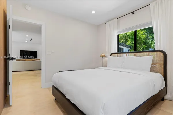 a large white bed in a white room