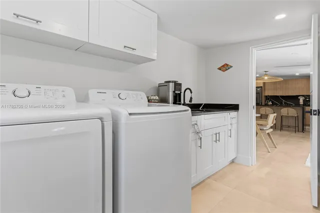 a kitchen with a sink and white cabinets