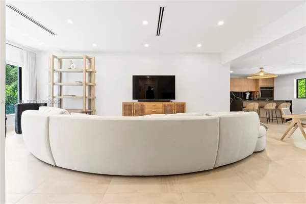 a living room with couches and a flat screen tv