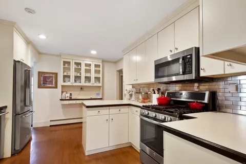 a kitchen with stainless steel appliances a stove sink microwave and cabinets