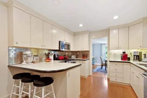 a kitchen with a sink cabinets and wooden floor