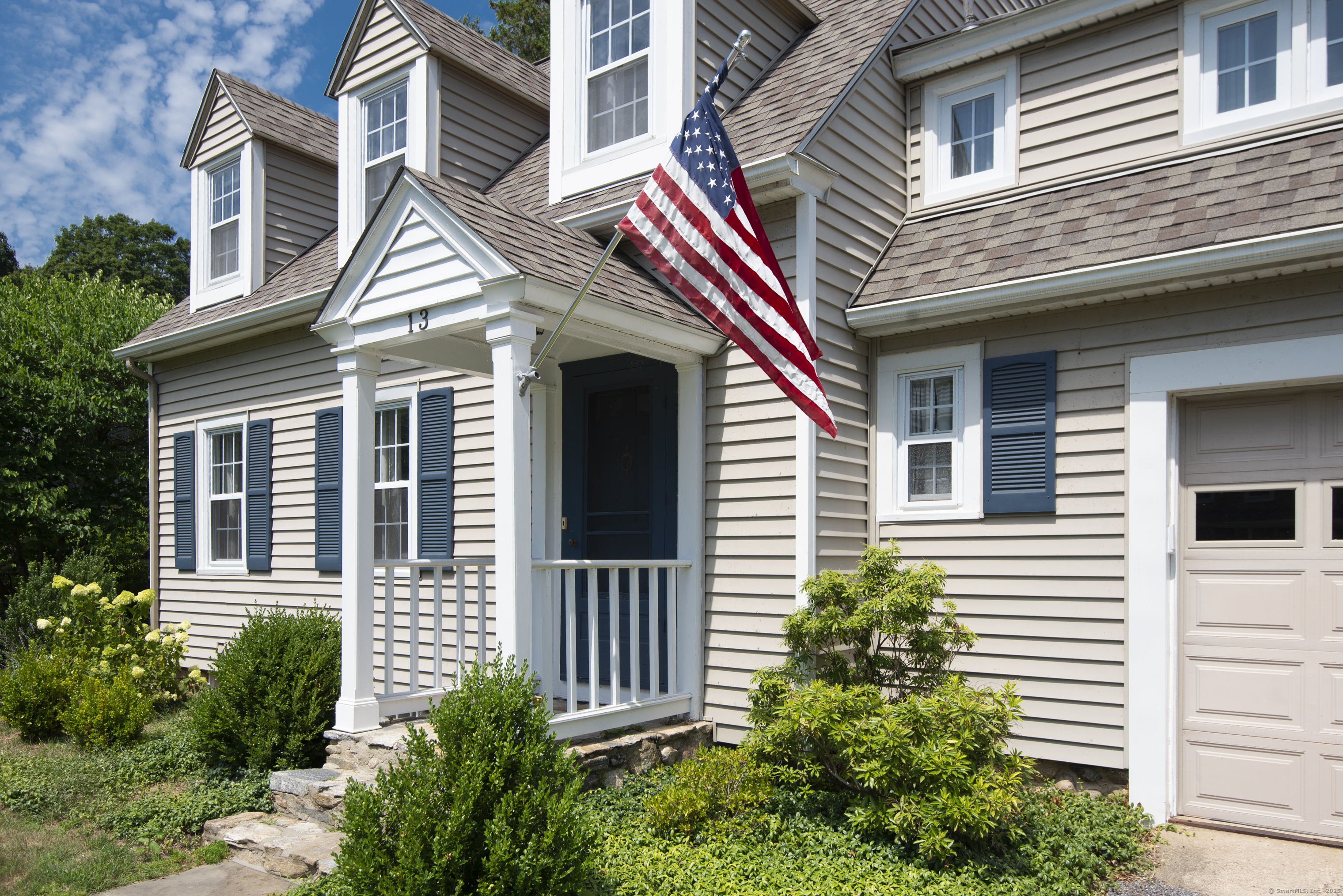 13 Maple Avenue Essex, CT 06426 - Photo 3 of 31 a view of a white house with a small window and potted plants