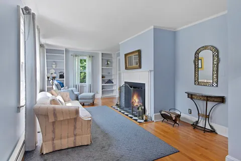 a living room with furniture and a fireplace