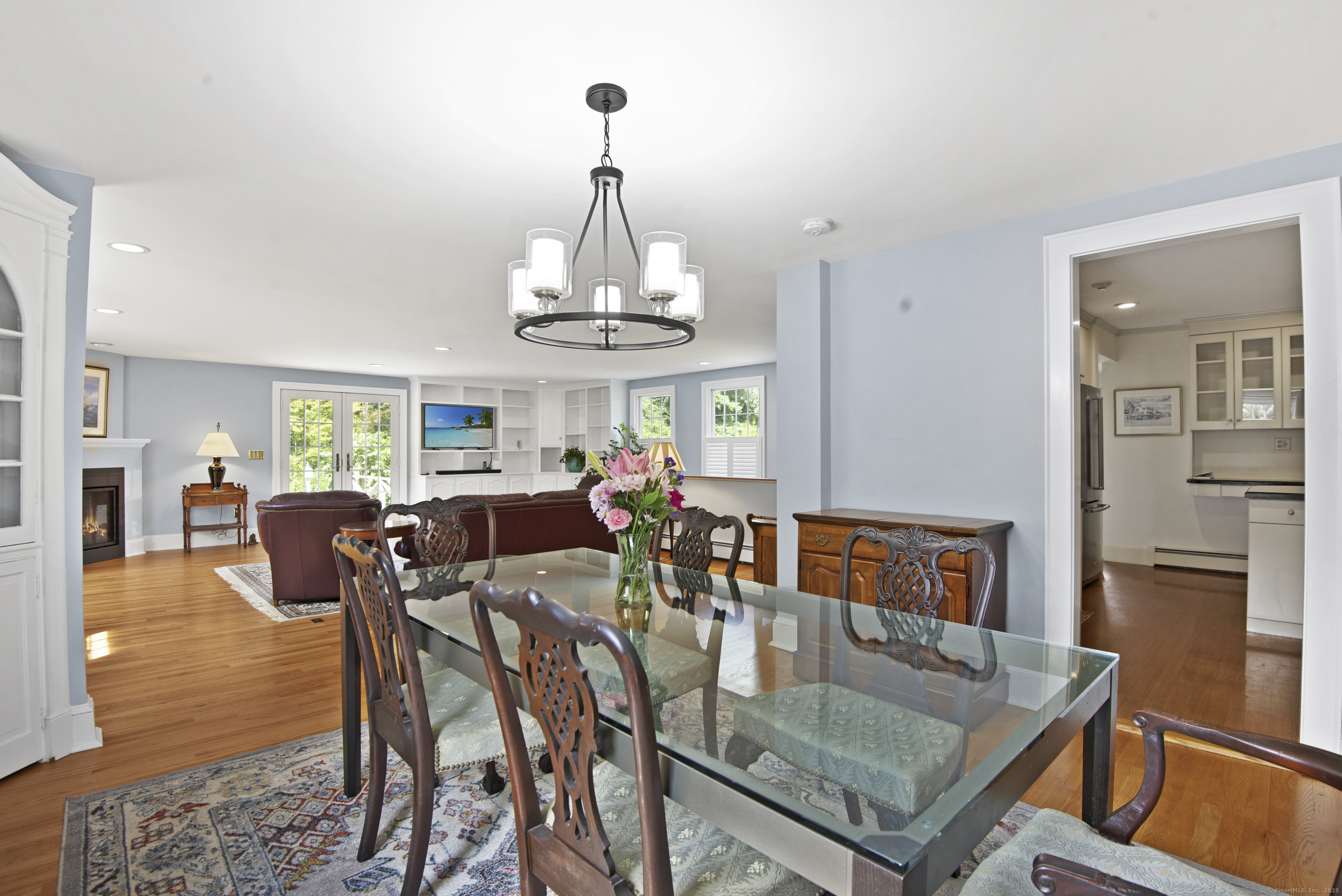 13 Maple Avenue Essex, CT 06426 - Photo 9 of 31 a view of a dining room and livingroom with furniture wooden floor a chandelier