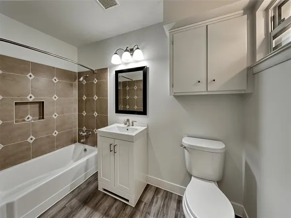 a bathroom with a sink a toilet and bathtub