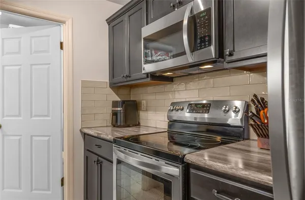a stove top oven sitting inside of a kitchen