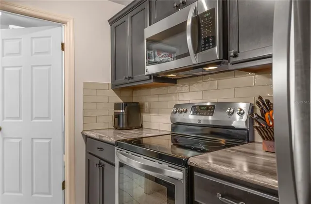 a stove top oven sitting inside of a kitchen