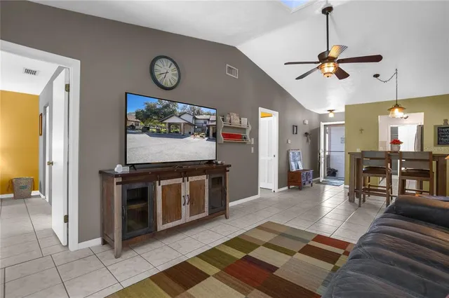 a view of a livingroom with furniture and a ceiling fan