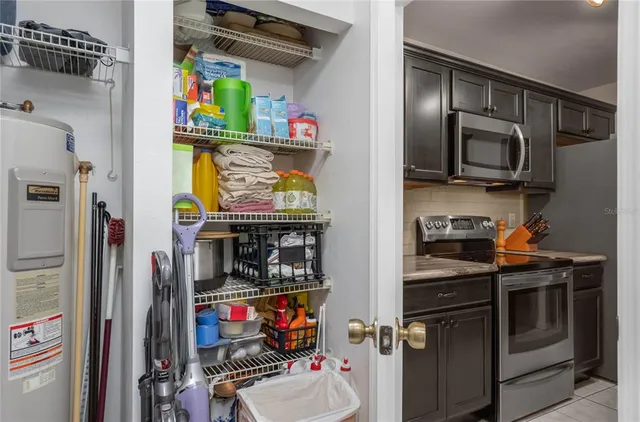a kitchen with stainless steel appliances granite countertop a refrigerator and a stove