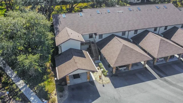 an aerial view of a house with swimming pool and wooden fence