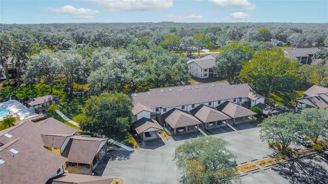 an aerial view of a house with a yard and lake view