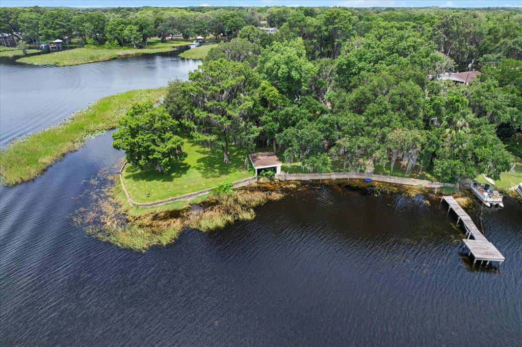 1226 South Telephone Point Road Inverness, FL 34450 - Photo 3 of 43 a view of a lake with a yard