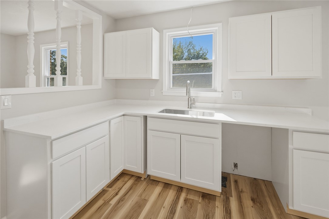 902 Cherokee Road Pelzer, SC 29669 - Photo 28 of 38 A well-lit kitchen boasts ample counter space and bright white cabinetry.