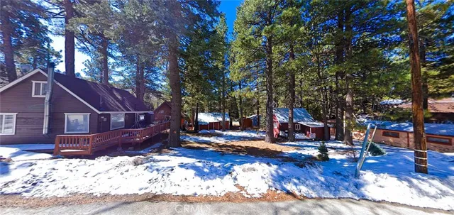 a view of a house with a large tree