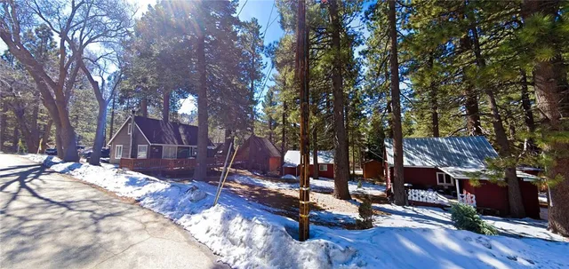 a view of a house with a yard covered with snow