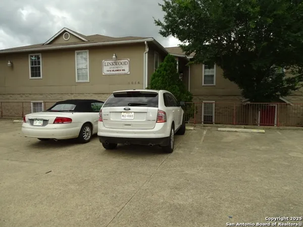 a white car parked in front of a house