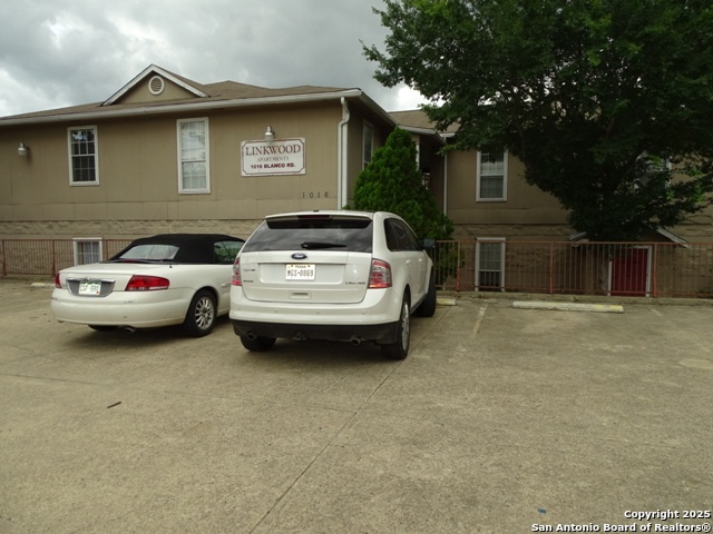 a white car parked in front of a house